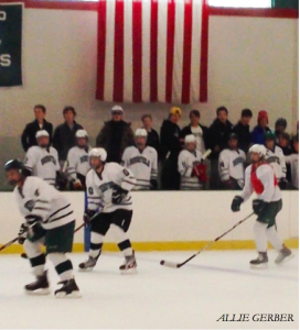 Fans crowd the bench as boys thirds hockey takes on girls JV.